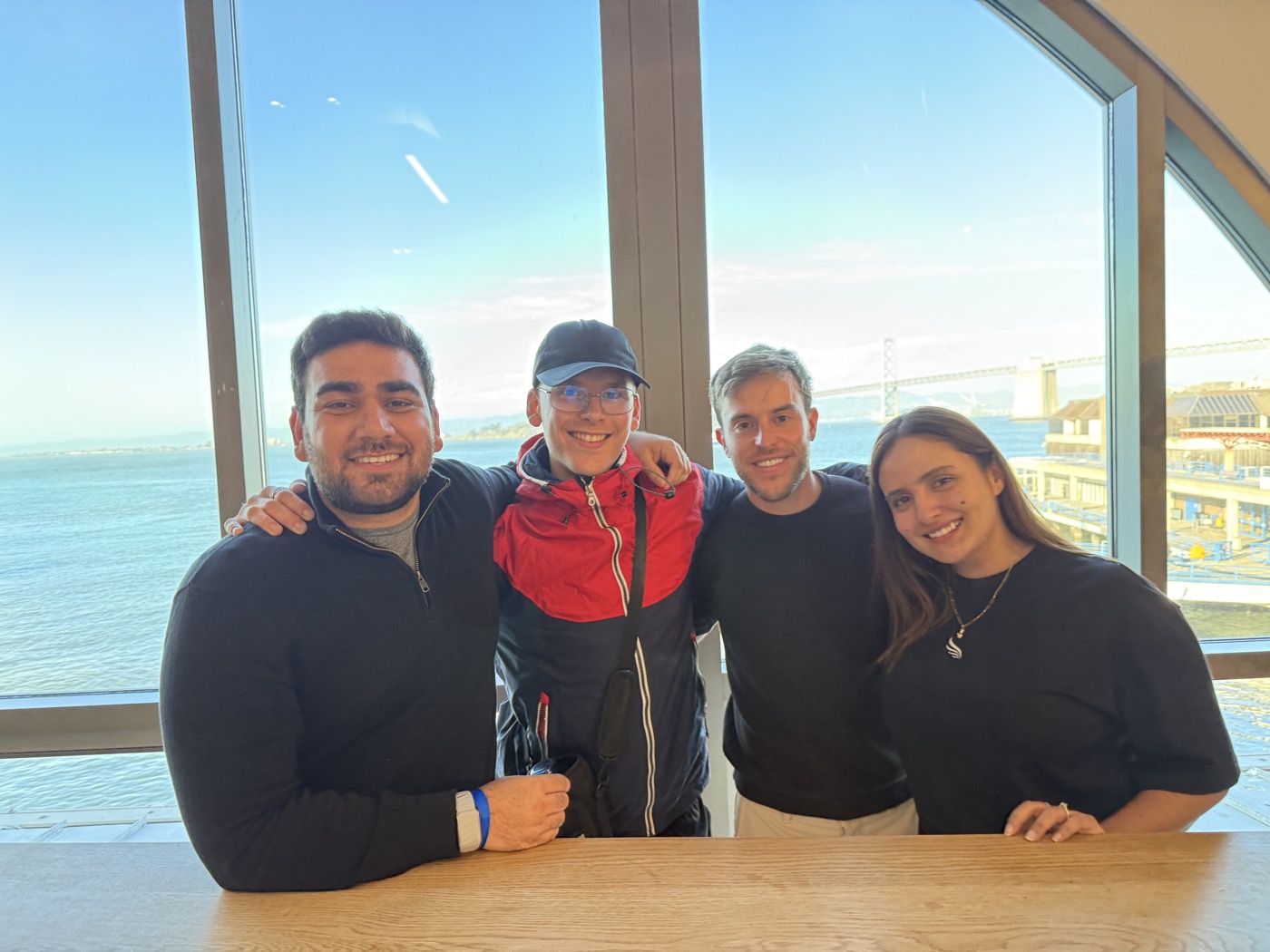 Four members of the Humanolab team together by a waterfront window